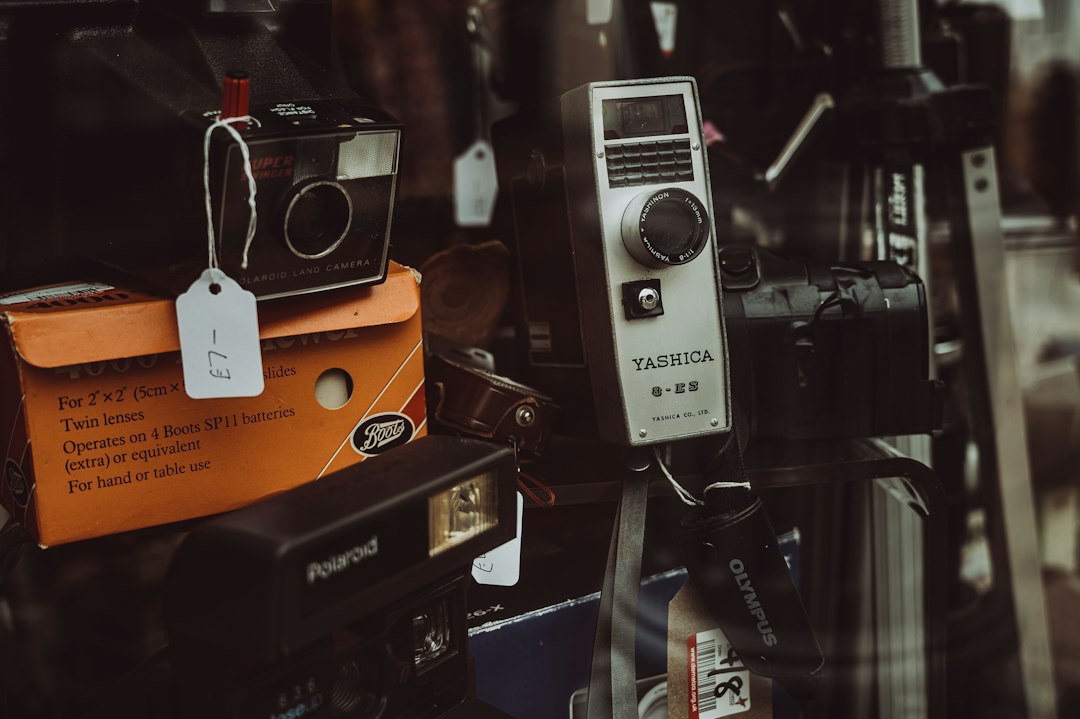 Professional camera equipment collection with vintage and modern cameras displayed